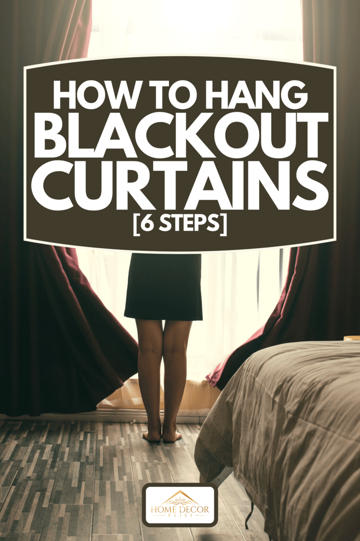 A woman opening blackout curtains on bedroom window, How To Hang Blackout Curtains [6 Steps]