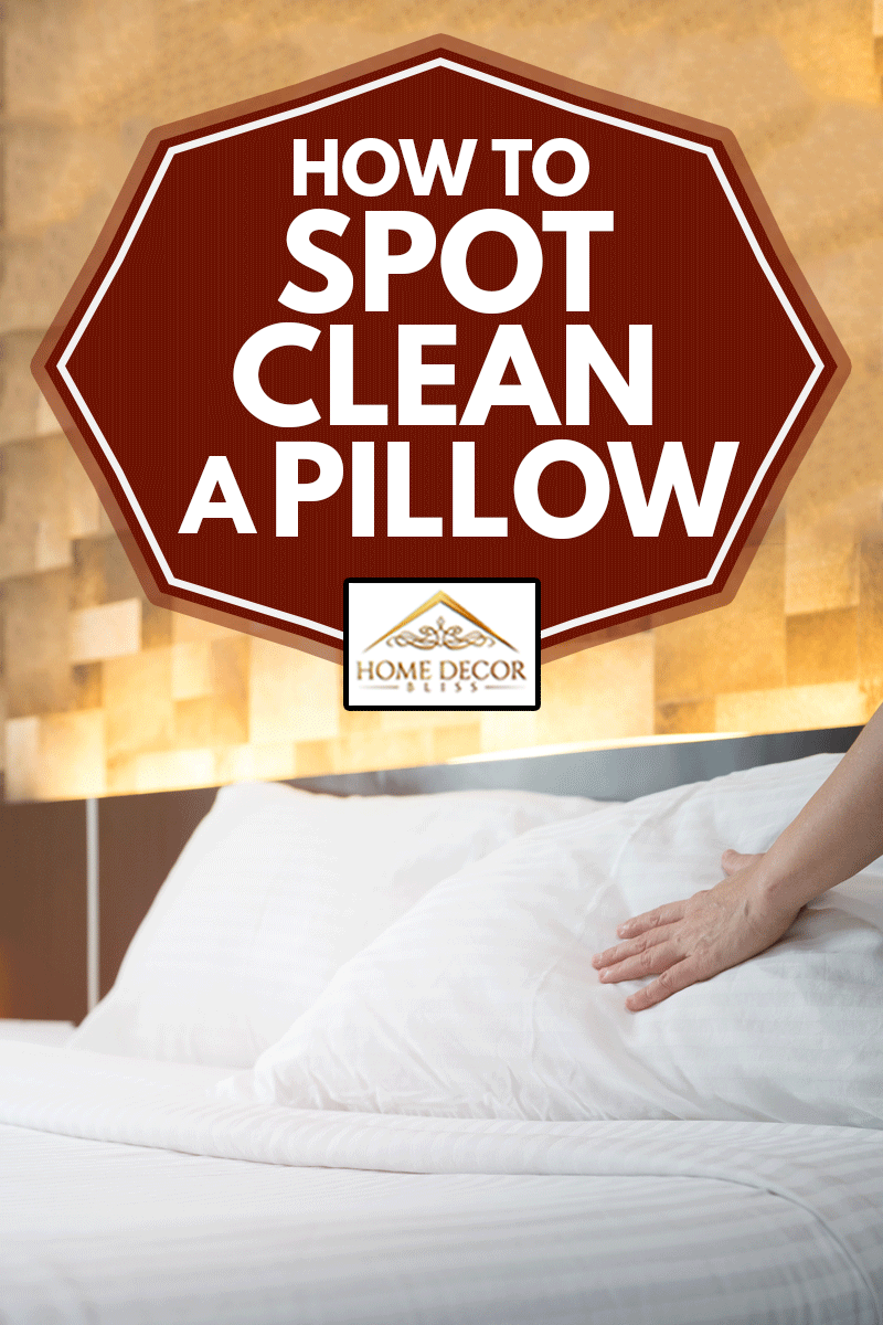 woman's hands set up white pillow on the bed, How To Spot Clean A Pillow