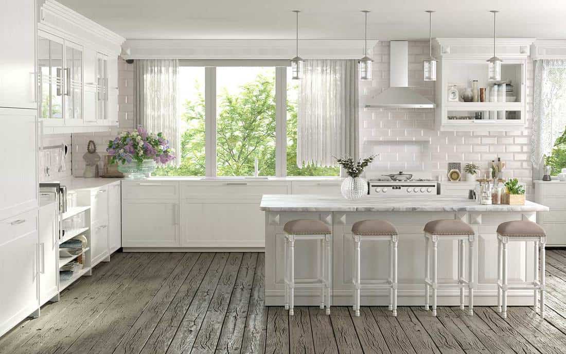 Kitchen interior design with island table, white brick walls and hardwood floor