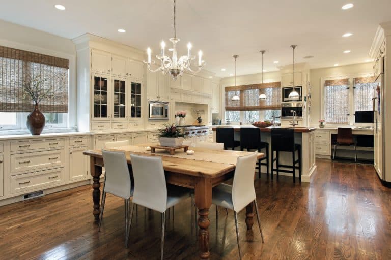 Kitchen with white cabinetry and coordinated chandeliers, Should Light Fixtures Match Throughout House?