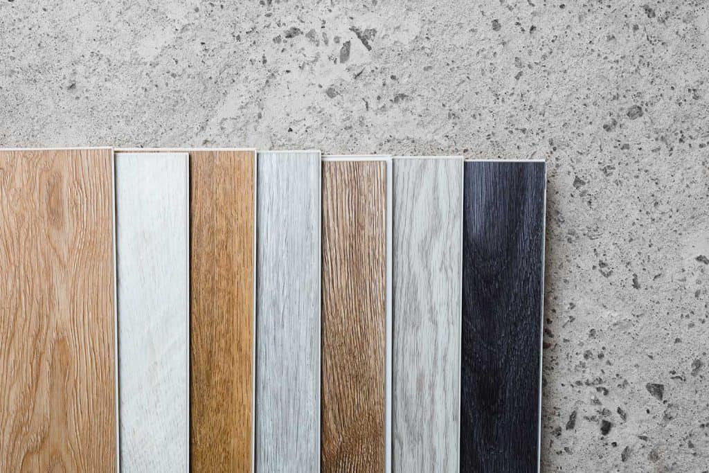 Laminate flooring planks variations on concrete floor