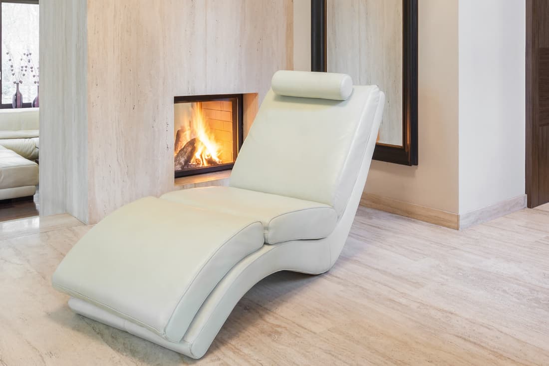 Luxurious modern chaise lounge by the fire