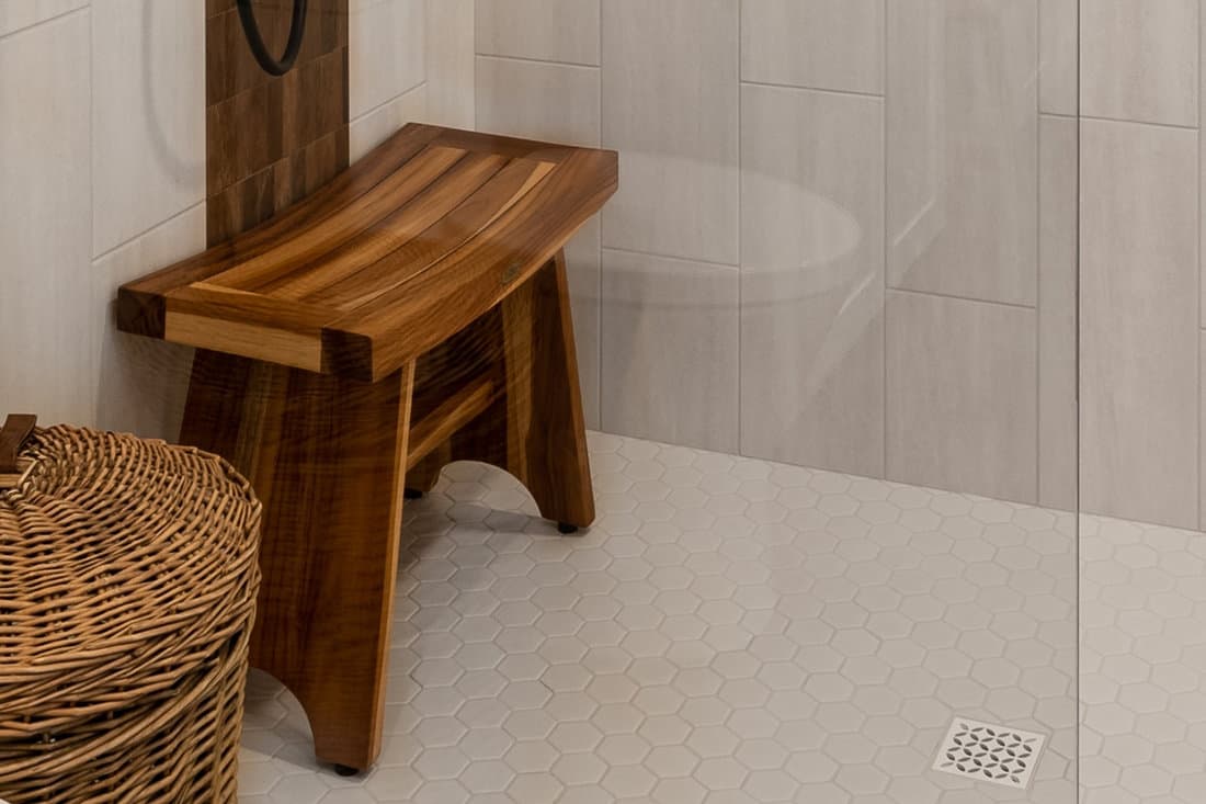 Modern bathroom shower with teak wood bench