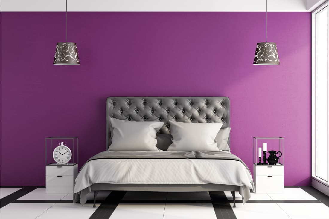 Modern magical master bedroom with leather bed and purple wall