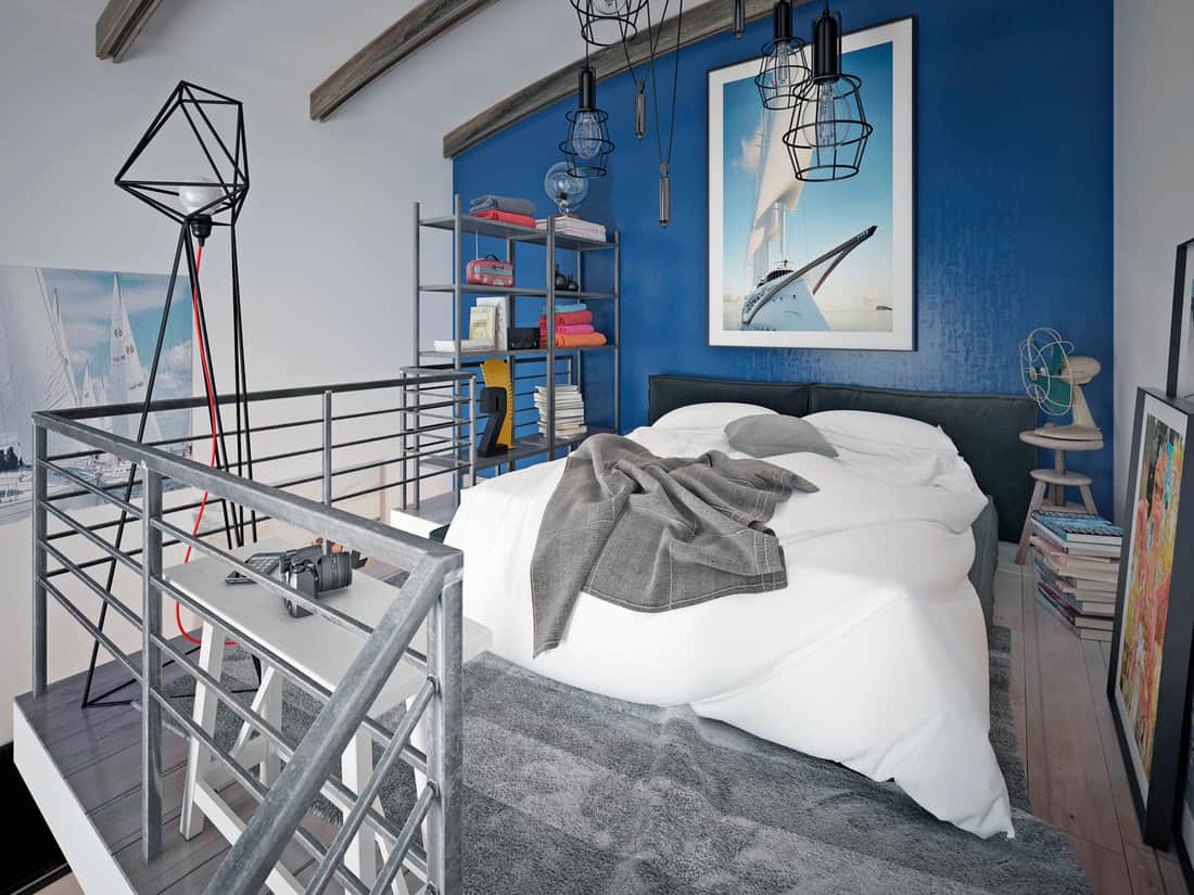 Chambre loft moderne pour adolescents avec moquette grise et mur bleu