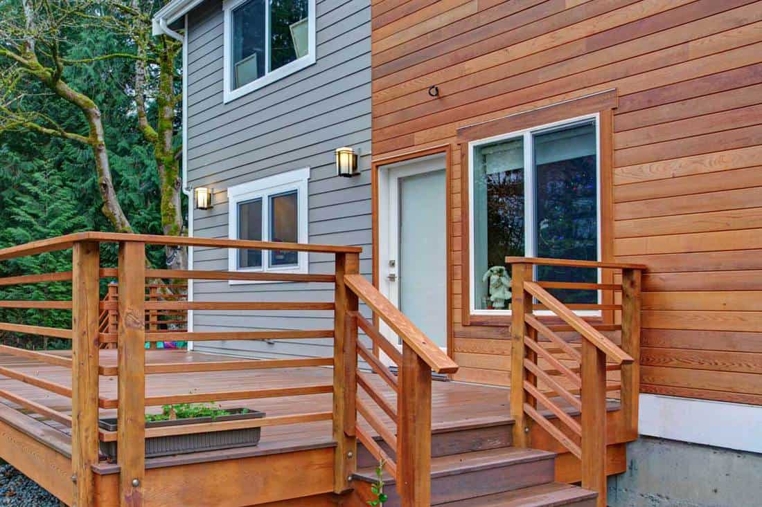 Newly renovated home exterior with wood siding, Should You Paint Or Stain Wood Siding (And How To)