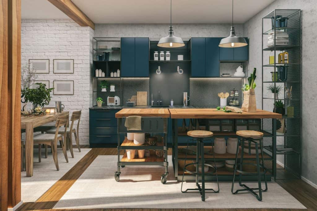 Retro inspired kitchen area with wooden countertops, dark blue colored cabinet panels, and a white rug under the breakfast bar