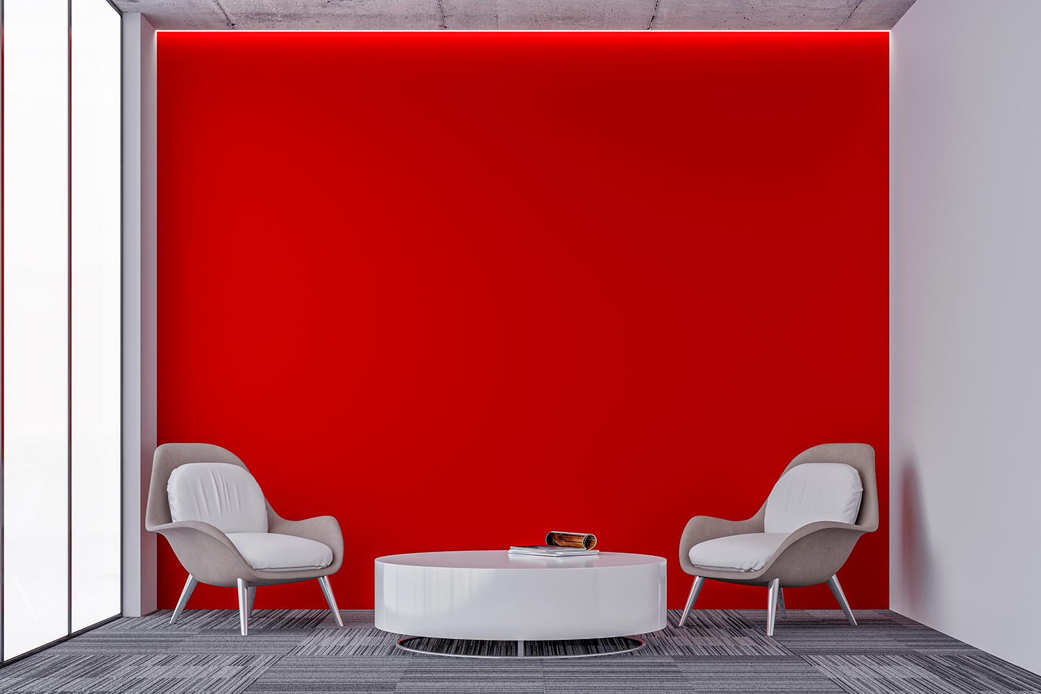 Round white glossy table and two comfort chairs in front of a large illuminated empty red plaster wall