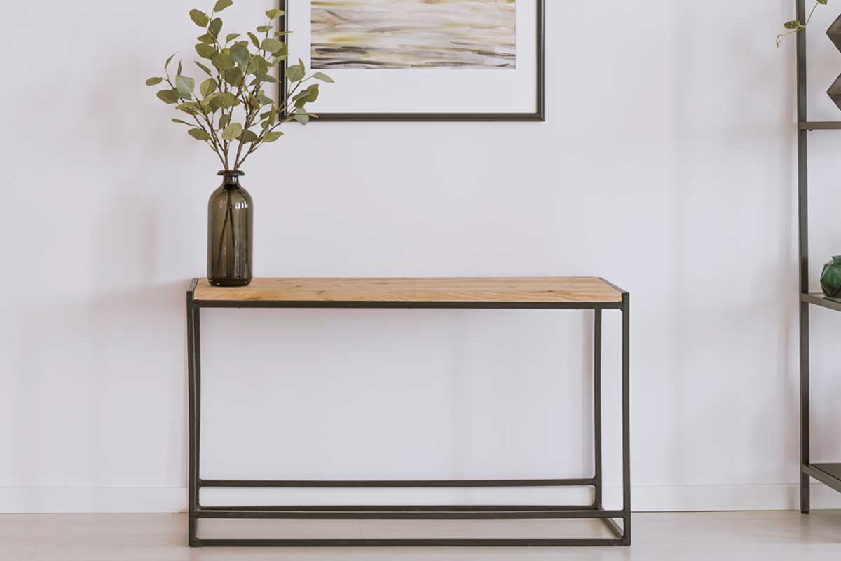 Simple painting above wooden console table with twigs in a glass vase in modern living room interior, Can A Console Table Be Used As A Desk?