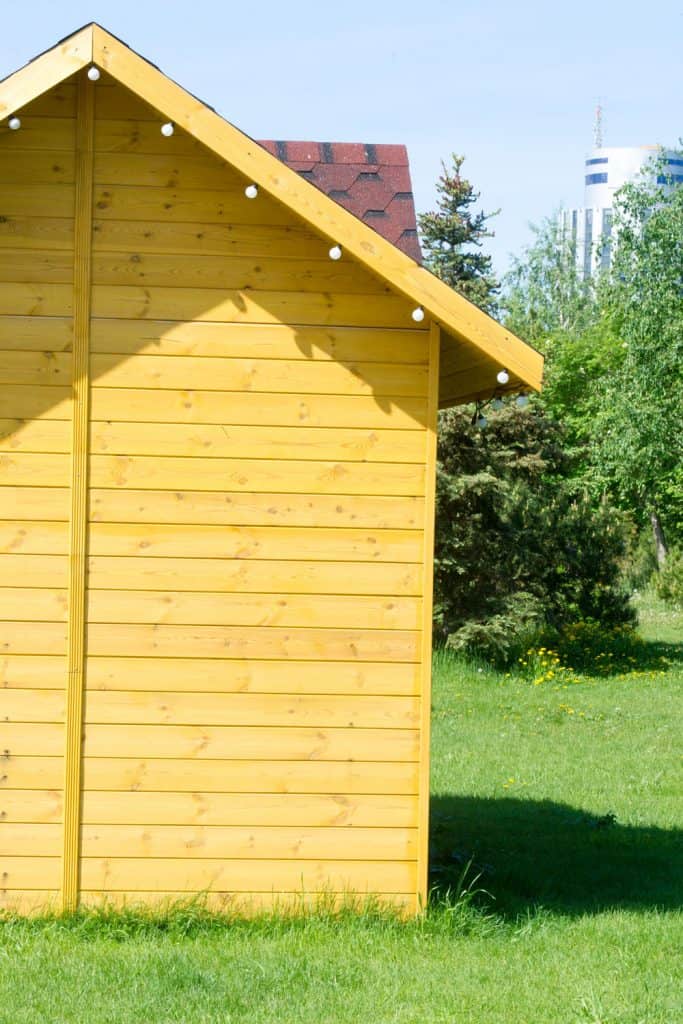 Small shed with yellow painted wooden sidings