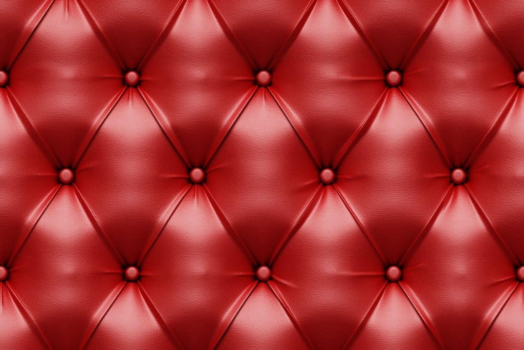 Up close photo of a red Natuzzi leather sofa