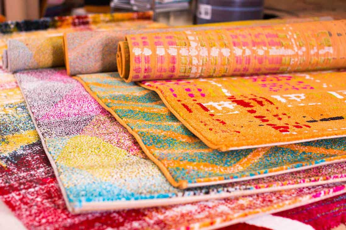 Various colorful wool rugs for sale at store, Where To Get A Rug Cut And Bound
