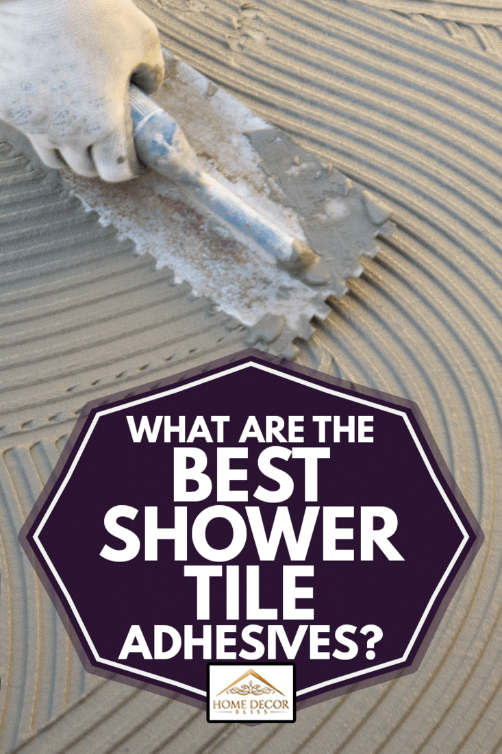 What Are The Best Shower Tile Adhesives?, The worker applies the glue to a tile on a concrete floor