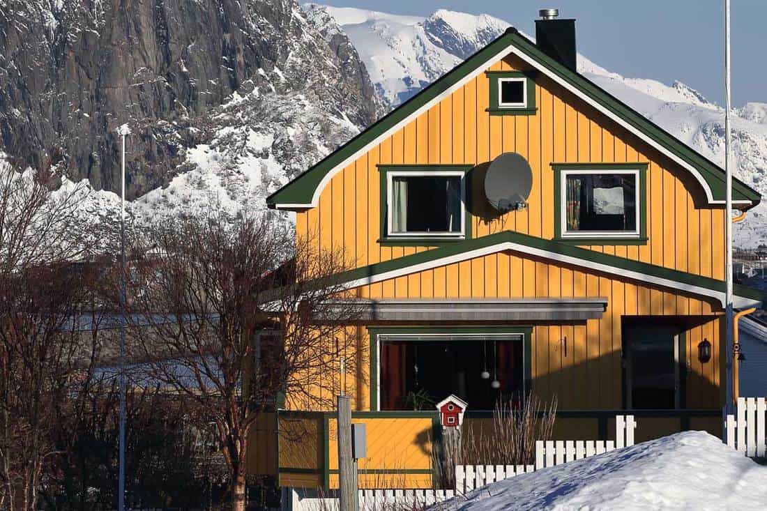 Yellow wooden cottage for residential purposes, 10 Types Of Board-And-Batten Siding