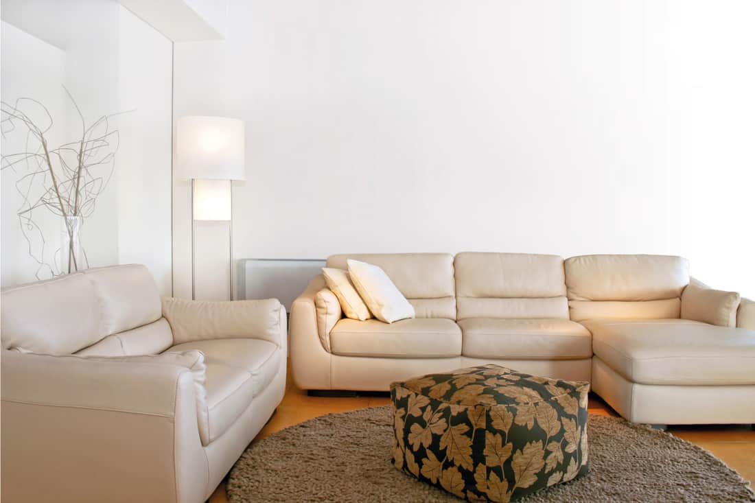 Bright living room with white sofa and a floor lamp in the corner