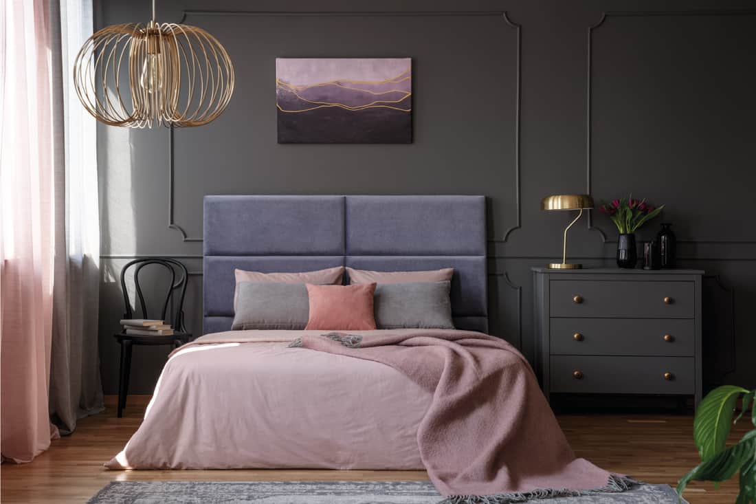 Elegant contemporary apartment, pink blankets, purple headboard and pink curtains