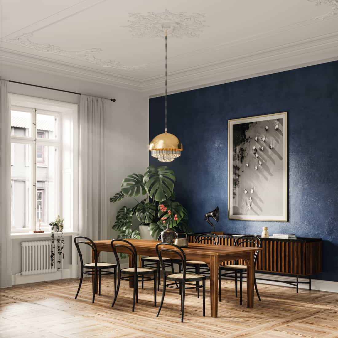 Elegant dining table in a modern home with dining table and chairs, chandelier and navy blue wall