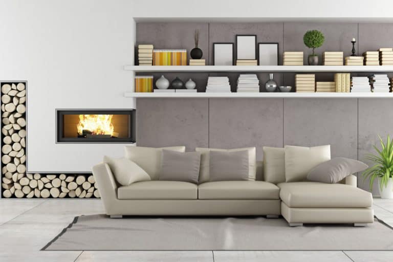 Light gray living room with a bookshelf and a fireplace, 31 Awesome Gray Living Room Ideas
