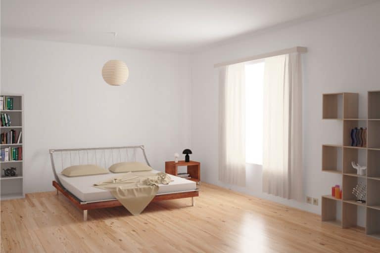light laminate flooring ina modern bedroom, metal frame bed, light curtains. Dark Vs Light Laminate Flooring - Which To Choose