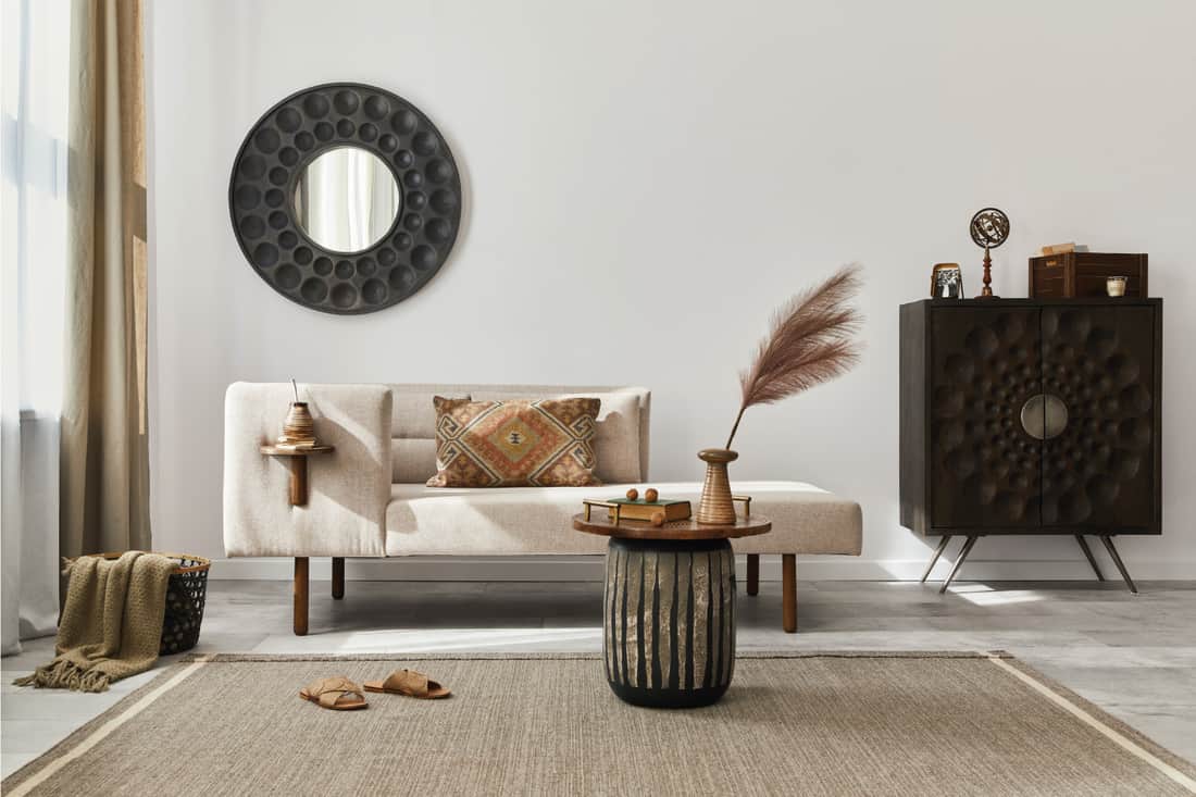 Living room with chaise lounge, round mirror, carpet, stool and elegant personal accessories