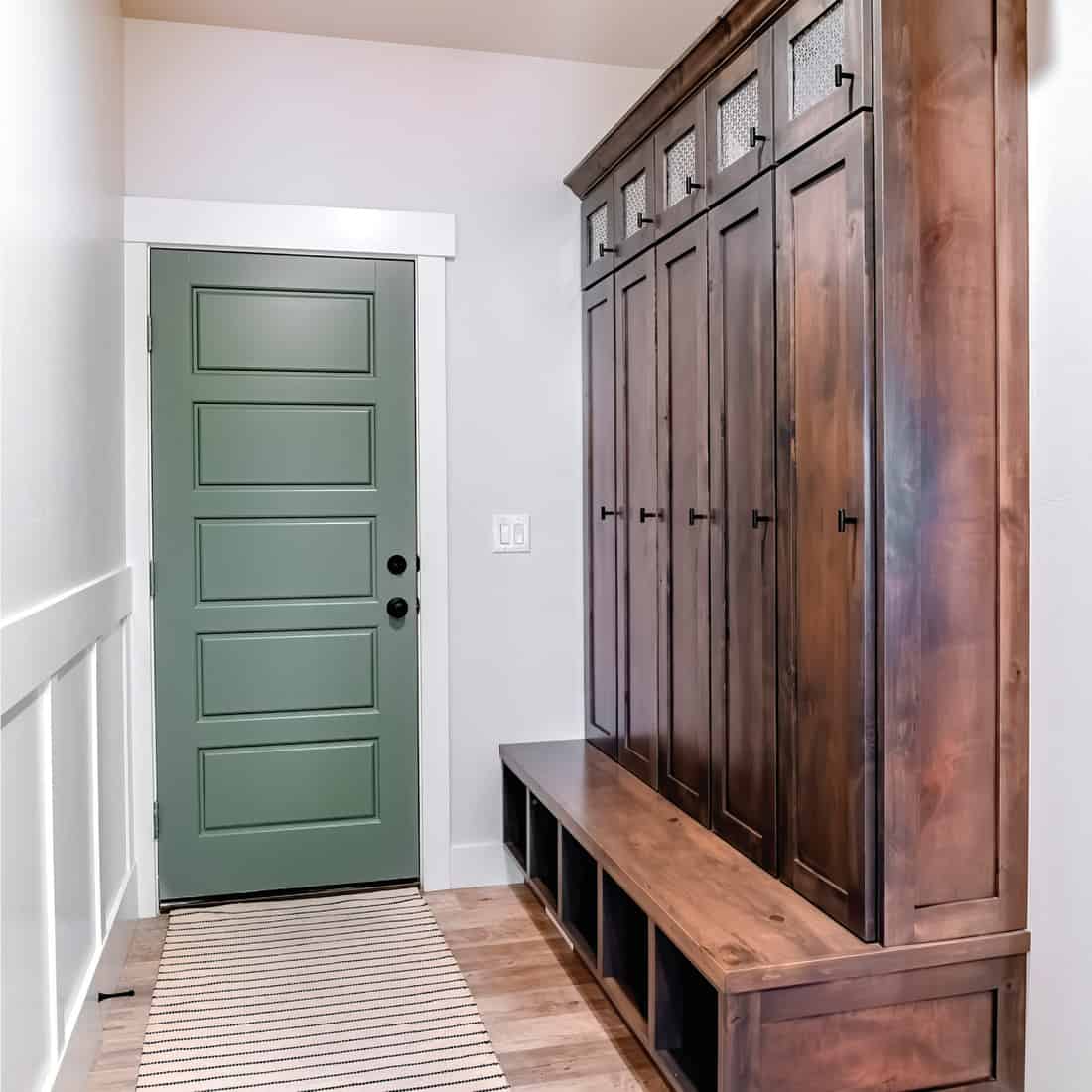 Long and narrow foyer rug inside a home with large cabinet on the side