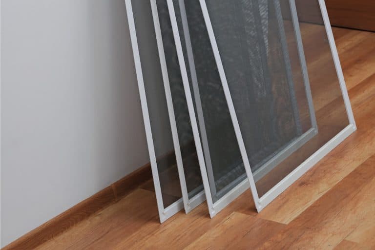 Pre-made screens for installation leaning on a wall, How Wide Is A Screen Door