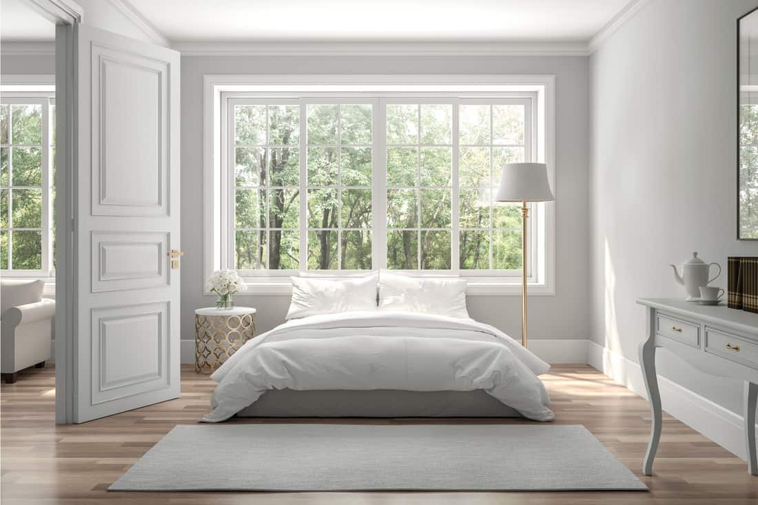 Wooden floors and gray walls, decorate with white furniture, large windows with a view
