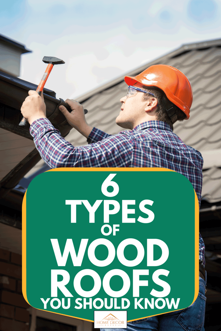 Worker with hard hat and hammer installing wood shingles, 6 Types Of Wood Roofs You Should Know
