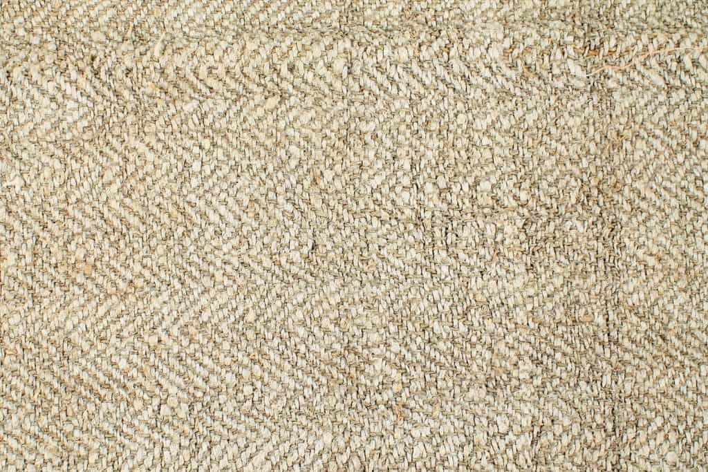 A detailed photo of a linen cloth fabric perfect for a living room carpet