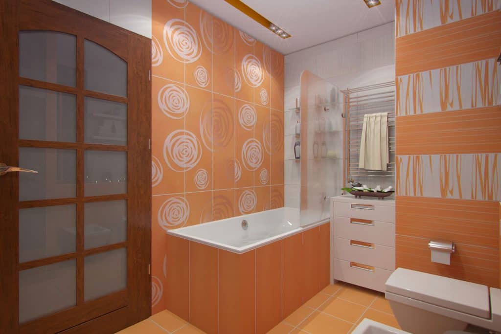A gorgeous modern bathroom with orange floral walls, orang flooring, and a hardwood entrance door 
