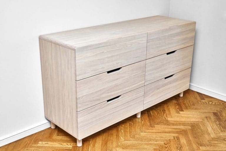 A heavy dresser on the corner of a living room, How To Move A Heavy Dresser [5 Practical Methods]