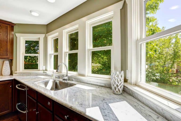 A kitchen cabinet with marble top and sink, How Big Should A Kitchen Window Be?
