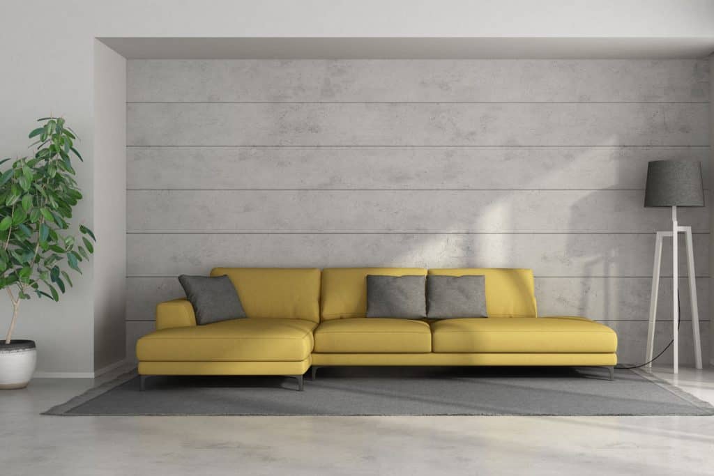 A mustard yellow sectional sofa inside a modern living room