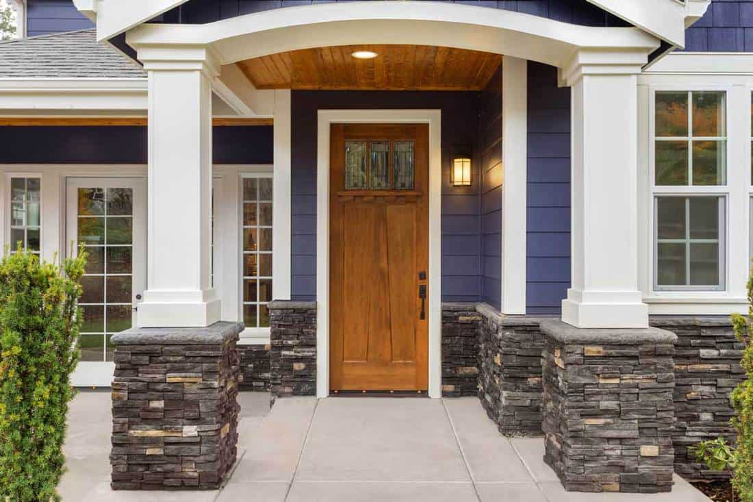 A new luxury home exterior patio and front door with arch and columns, 11 Timeless Porch Column Ideas