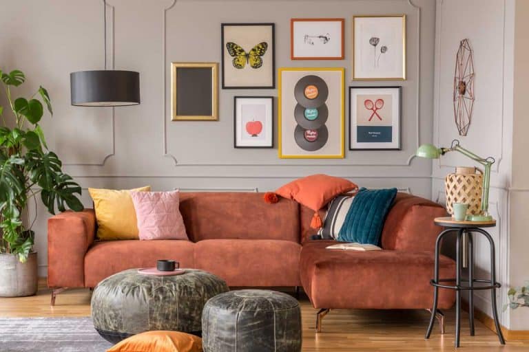 A vintage black poufs in trendy eclectic living room interior with brown couch, 11 Eye-Catching Living Room Wall Decor Ideas