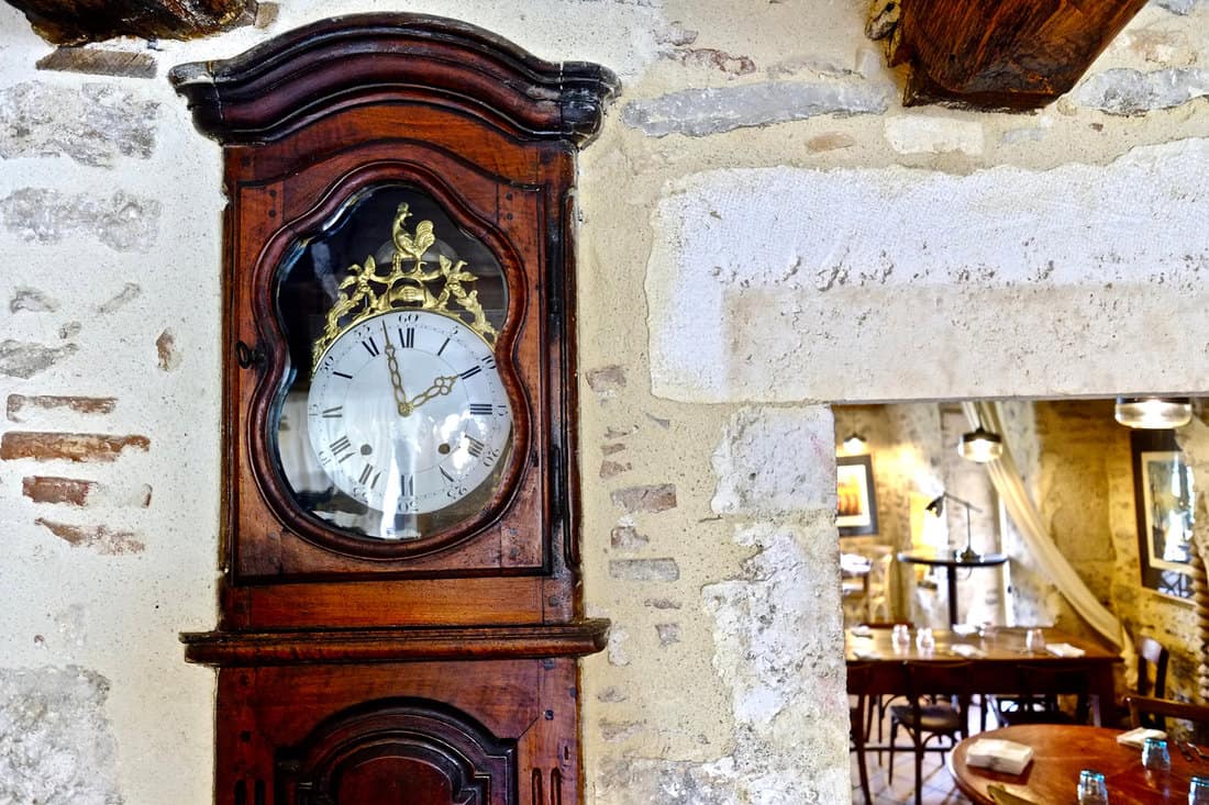 An ancient clock fixed into a wall just before the french revolution somewhere in the south of France. 