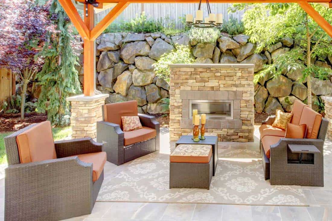 An exterior covered patio with fireplace and furniture, Should Outdoor Furniture Match?