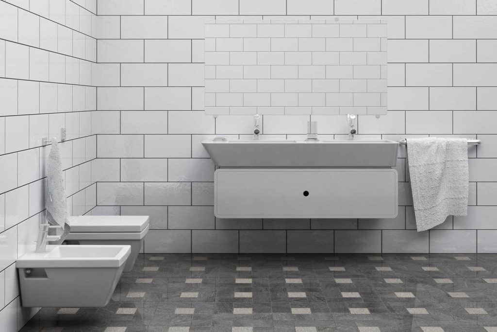 Bathroom interior with wall-hung toilet, tile floor and walls