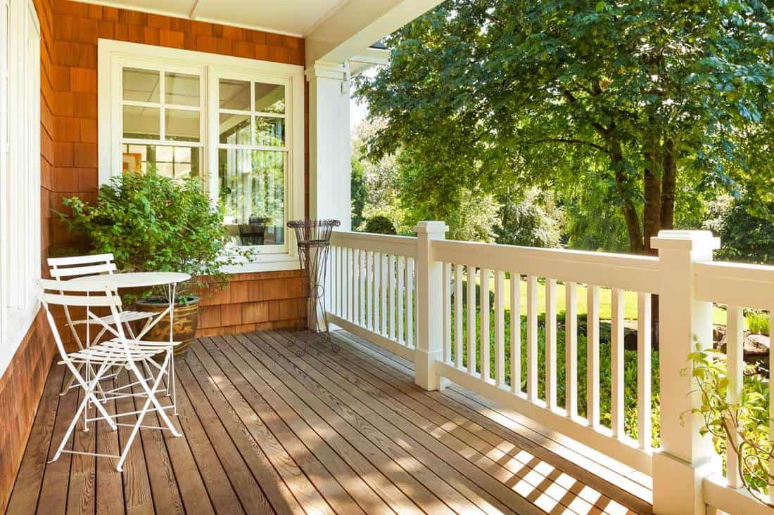 Beautiful front porch with table and chairs, on a lovely summer day, 100 Fabulous Front Porch Ideas