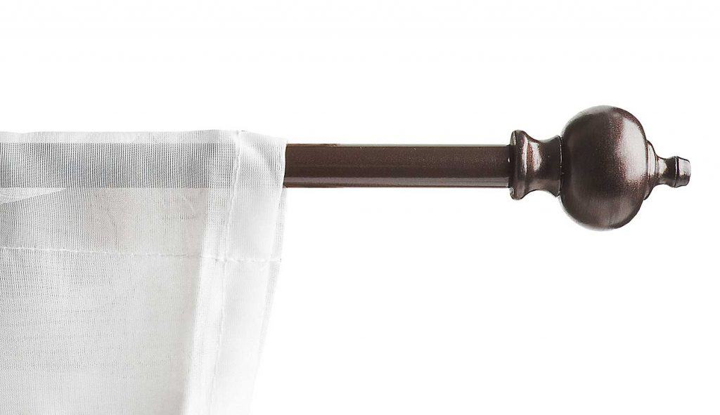 Brown bronze curtain rod with a white lave curtain on it