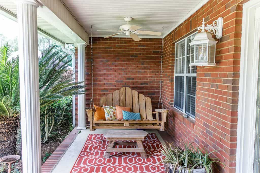 Colorful and modern bohemian boho outdoor front porch decoration with seating and a plant