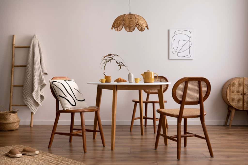Contemporary dining room with wooden chairs and white walls and laminated flooring, Can You Mix Leather And Fabric Furniture?