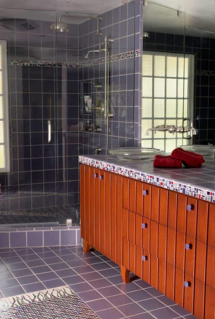 Custom upscale bathroom with purple tile wall and floor
