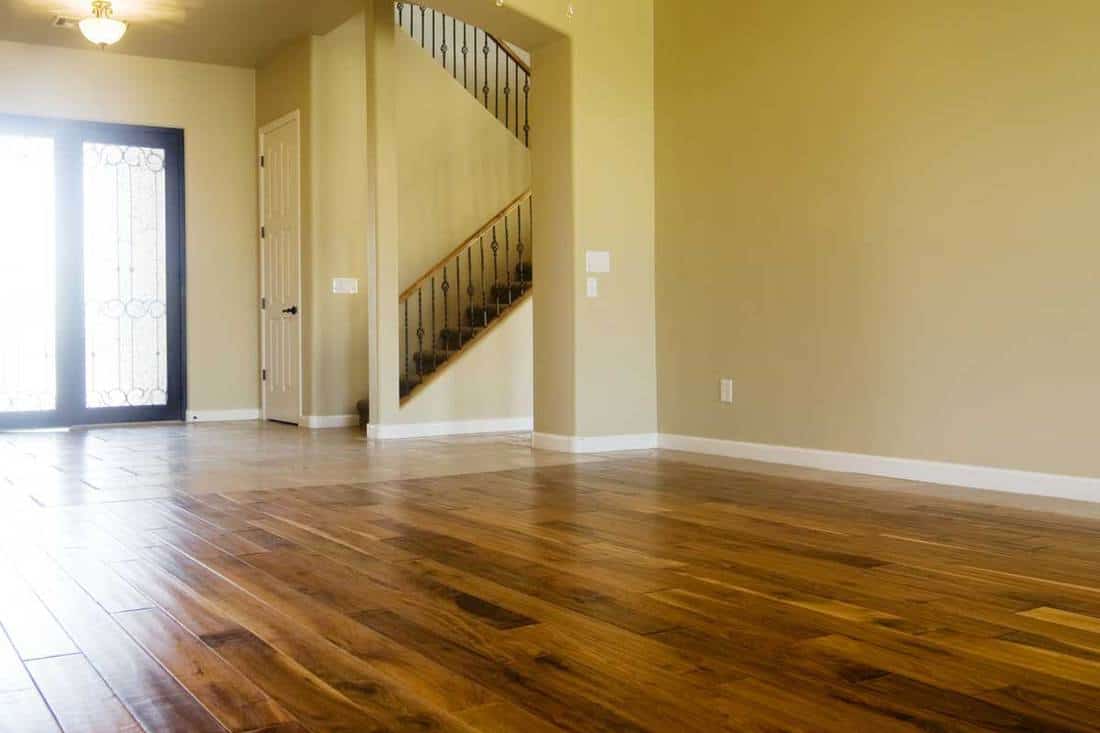 Dark stained hardwood flooring in kitchen area of new home, 17 Stunning Hardwood Floor And Wall Color Combinations