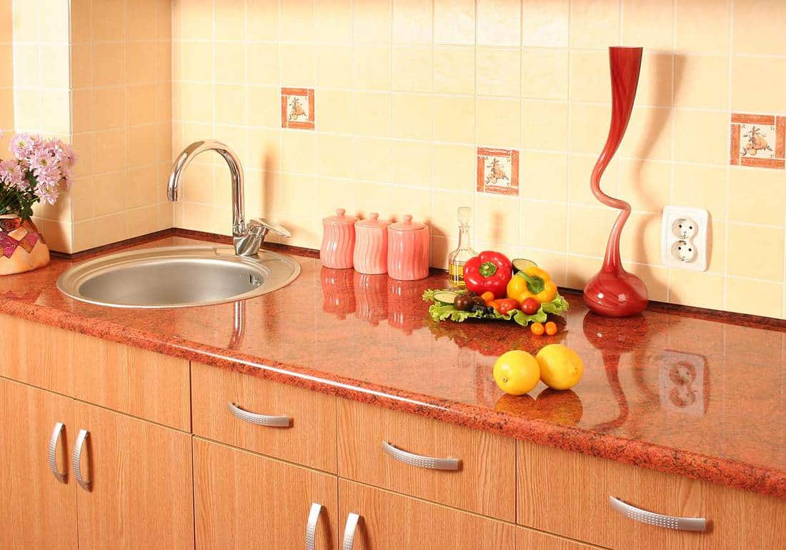 Domestic kitchen sink with wooden cabinets