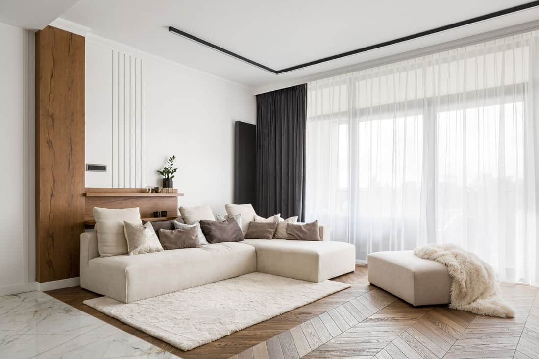 Elegant and comfortable designed living room with big corner sofa, wooden floor and big windows, Do Ceilings Always Have To Be White?