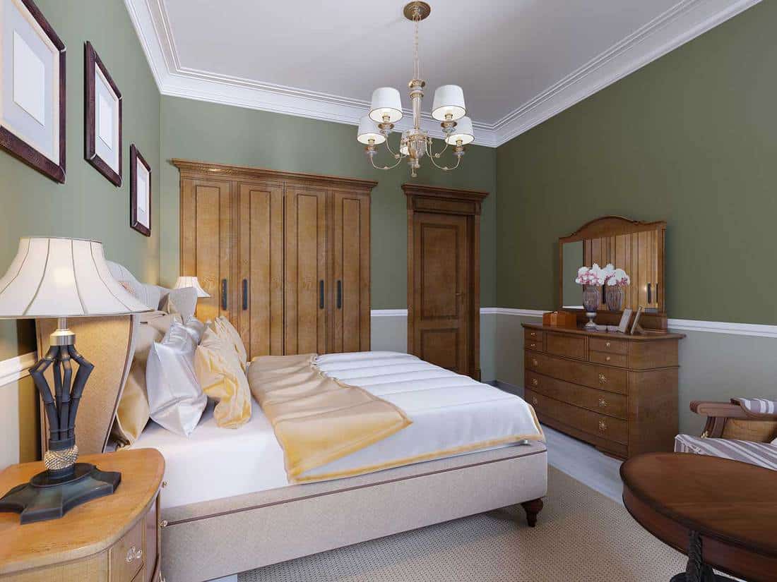 English-style bedroom with a large soft fabric bed, bedside tables with lamps, large wardrobe and dresser with mirror
