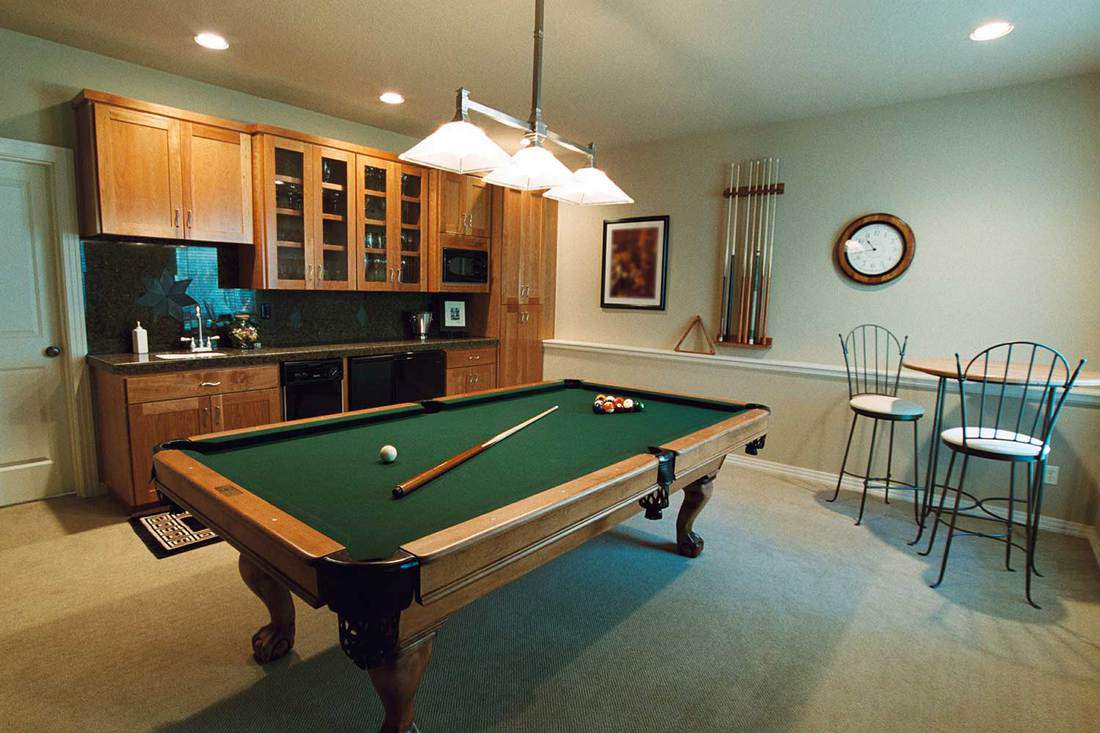 Entertainment room with billiards and wooden cabinets