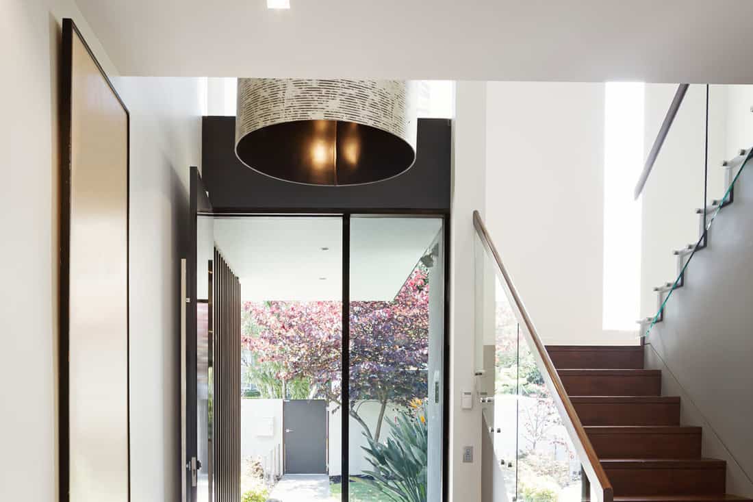 Entry foyer of architect designed modern Australian home with wooden floor and staircase