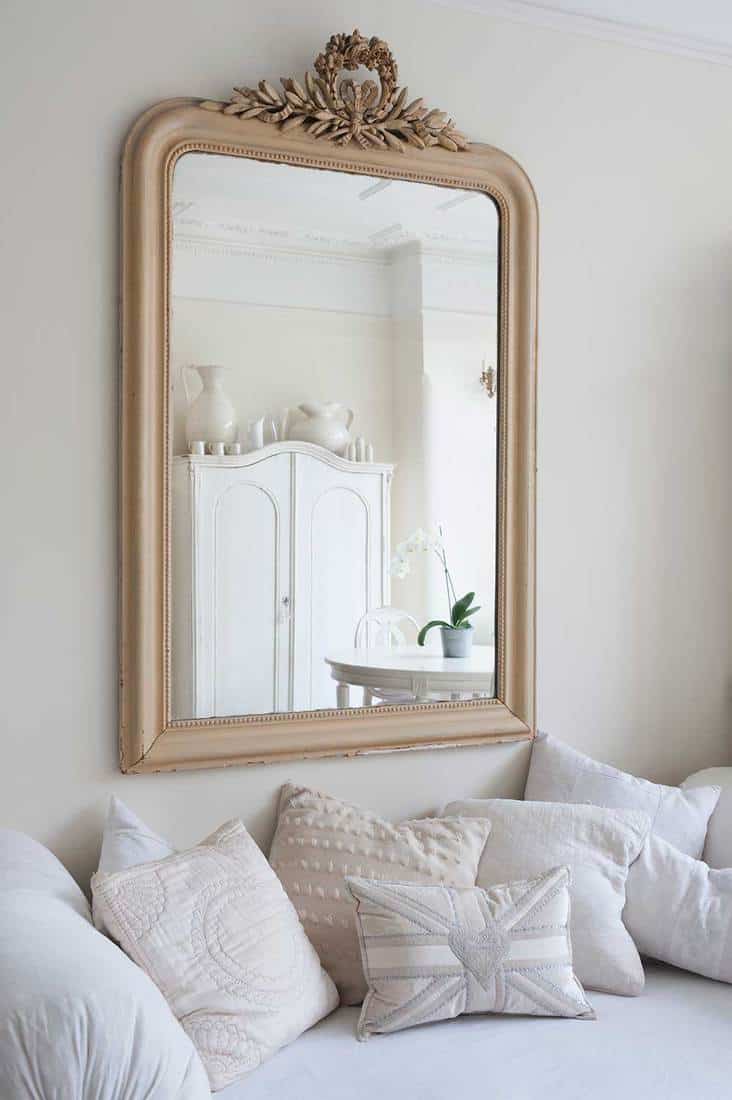 Framed mirror above daybed